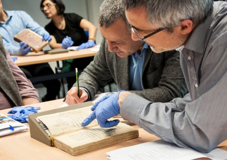 a group of researchers exploring a book
